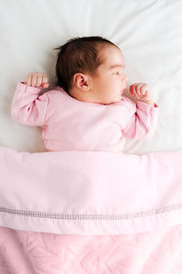 High angle view of baby sleeping on bed