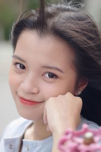 Close-up portrait of smiling young woman