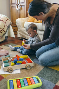 Mother and son playing with toys at home