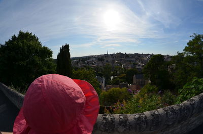 Close-up of pink hat against buildings and sky in town on sunny day