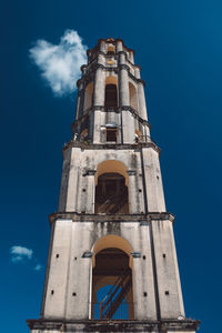 Low angle view of clock tower against blue sky