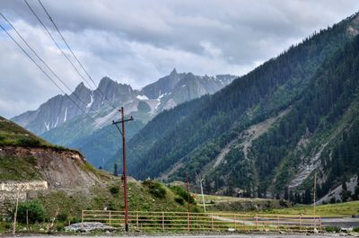 Scenic view of mountains against cloudy sky