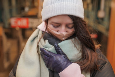 Woman wearing mask and warm clothing