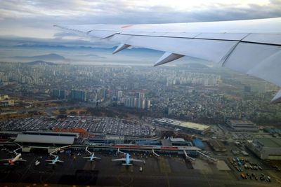 Aerial view of cityscape seen through airplane window