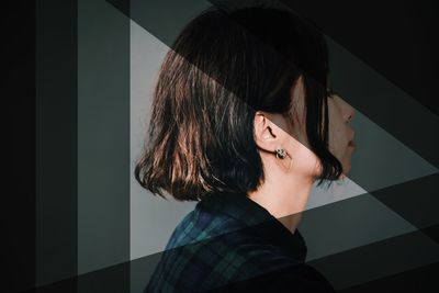 Portrait of woman standing against wall