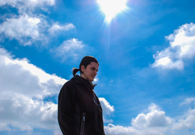 Portrait of young man against sky