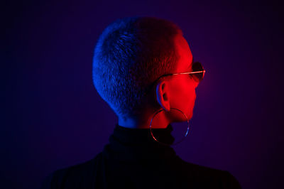 Portrait of man wearing mask against black background