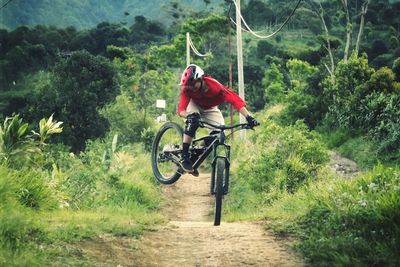 Rear view of man riding bicycle on mountain