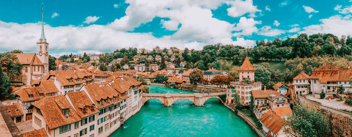 Panoramic view of buildings against cloudy sky