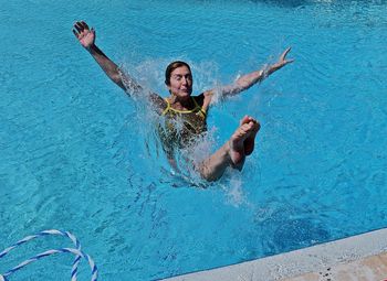 Full length of young woman in swimming pool