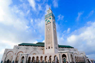 Low angle view of mosque hassan ii against sky in city