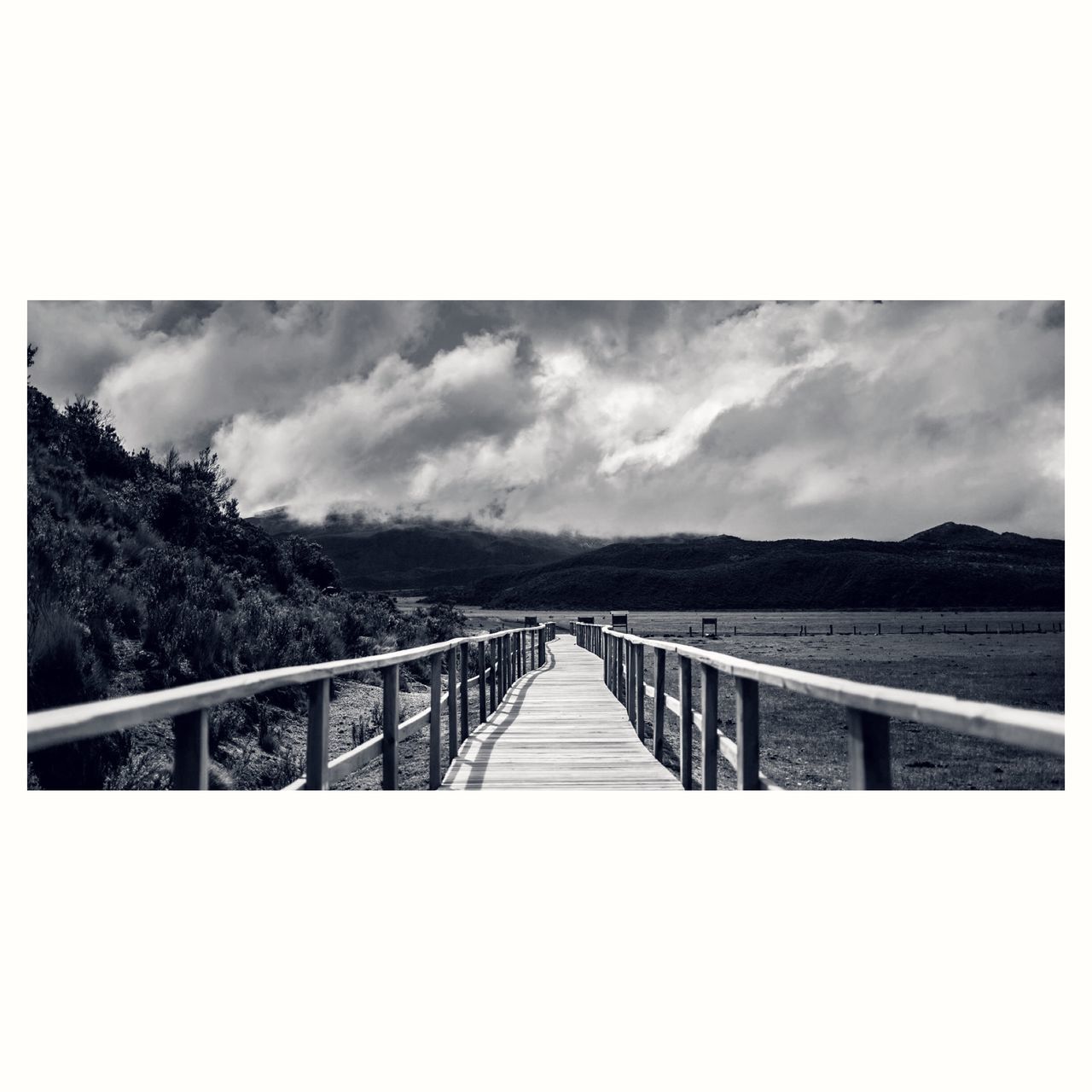 the way forward, sky, diminishing perspective, railing, vanishing point, tranquility, transfer print, cloud - sky, tranquil scene, connection, long, scenics, nature, bridge - man made structure, cloudy, cloud, auto post production filter, landscape, footbridge, water