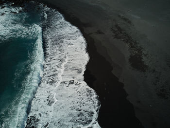 Waves and black sand beach on the shore of the atlantic ocean in lanzarote spain