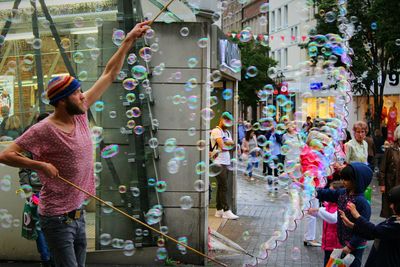 Full length of woman holding multi colored umbrella