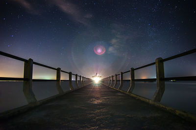 Scenic view of river against clear sky at night