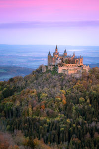 Hohenzollern castle in germany and the autumn forest at sunset