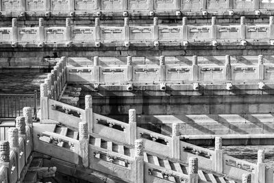 High angle view of old pier over river against buildings