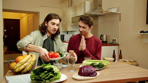 Young man preparing food in kitchen at home