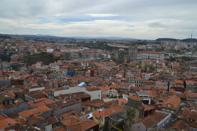 High angle view of houses in city against sky