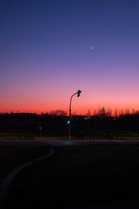 Silhouette street against sky at night