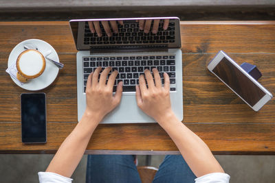 Directly above view of man using laptop on table