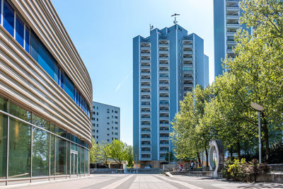 Low angle view of buildings against clear blue sky