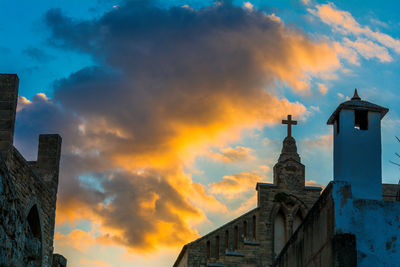 Low angle view of building against sky during sunset