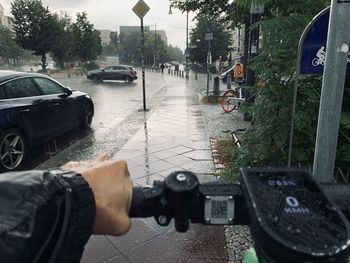 Man driving car on street in rainy season