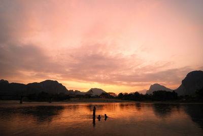 Scenic view of lake at sunset