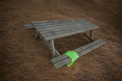 High angle view of empty bench on field