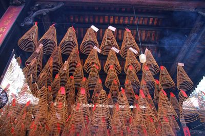 Low angle view of illuminated roof hanging outside building