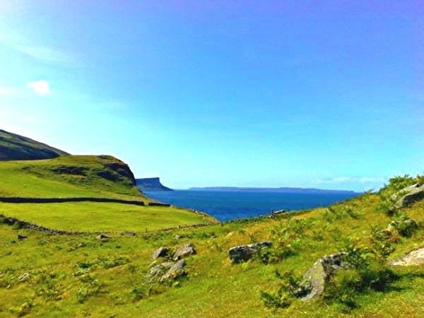 tranquil scene, tranquility, scenics, beauty in nature, landscape, mountain, blue, nature, copy space, clear sky, green color, sky, idyllic, grass, non-urban scene, water, hill, sea, mountain range, remote