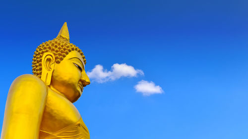 Low angle view of statue against blue sky