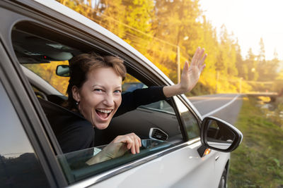 Portrait of happy woman in car