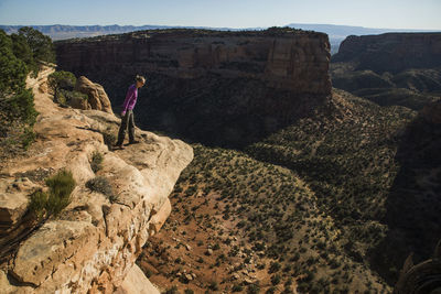 A young woman enjoys a view over colorado national monument in co.