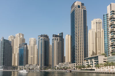 Modern buildings in city against clear sky