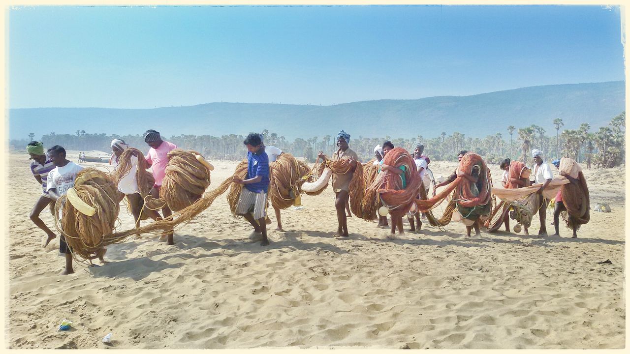 domestic animals, animal themes, mammal, clear sky, transfer print, large group of people, men, sand, livestock, horse, camel, auto post production filter, landscape, lifestyles, mountain, working animal, leisure activity, sky, beach