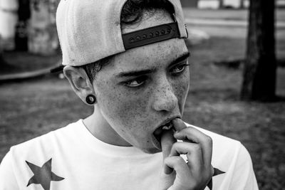 Close-up of teenage boy eating food at outdoors