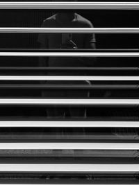 Full length of man sitting on staircase