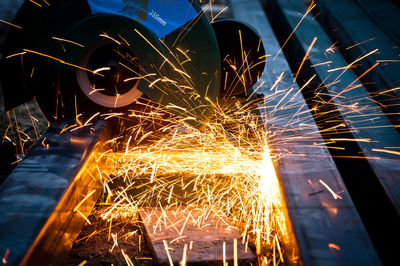 Sparks emitting from electric saw in darkroom