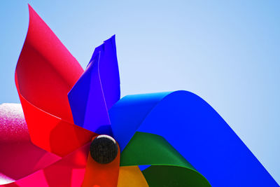 Low angle view of colorful pinwheel toy against clear sky