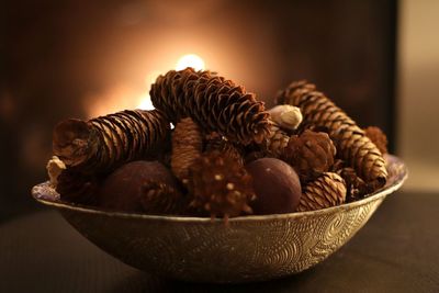 Close-up of pine cones in bowl on table