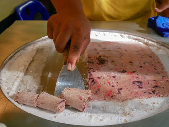 Midsection of person preparing food on table