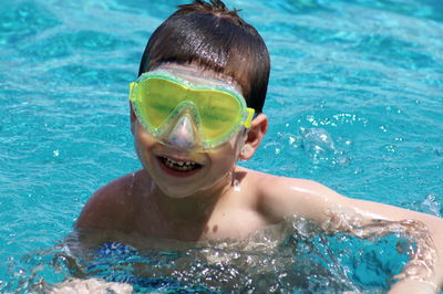 Close-up of boy swimming in water