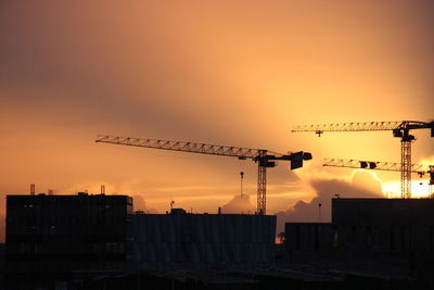 Silhouette cityscape against sky during sunset