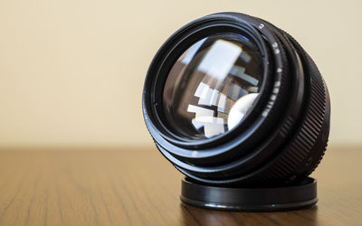 Close-up of camera lens on table