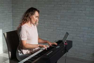 Young woman using laptop at home