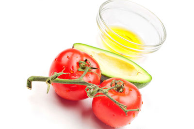 High angle view of tomatoes in bowl against white background