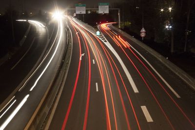 High angle view of light trails on highway at night