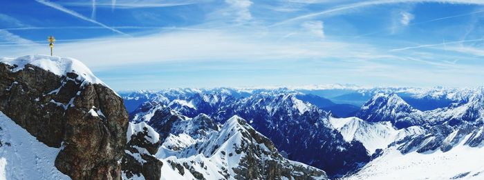 Snow covered mountains against blue sky